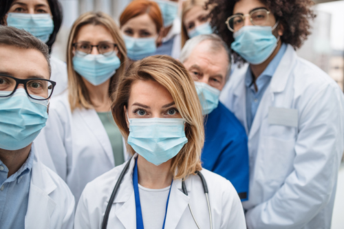 Doctors line up in surgical masks