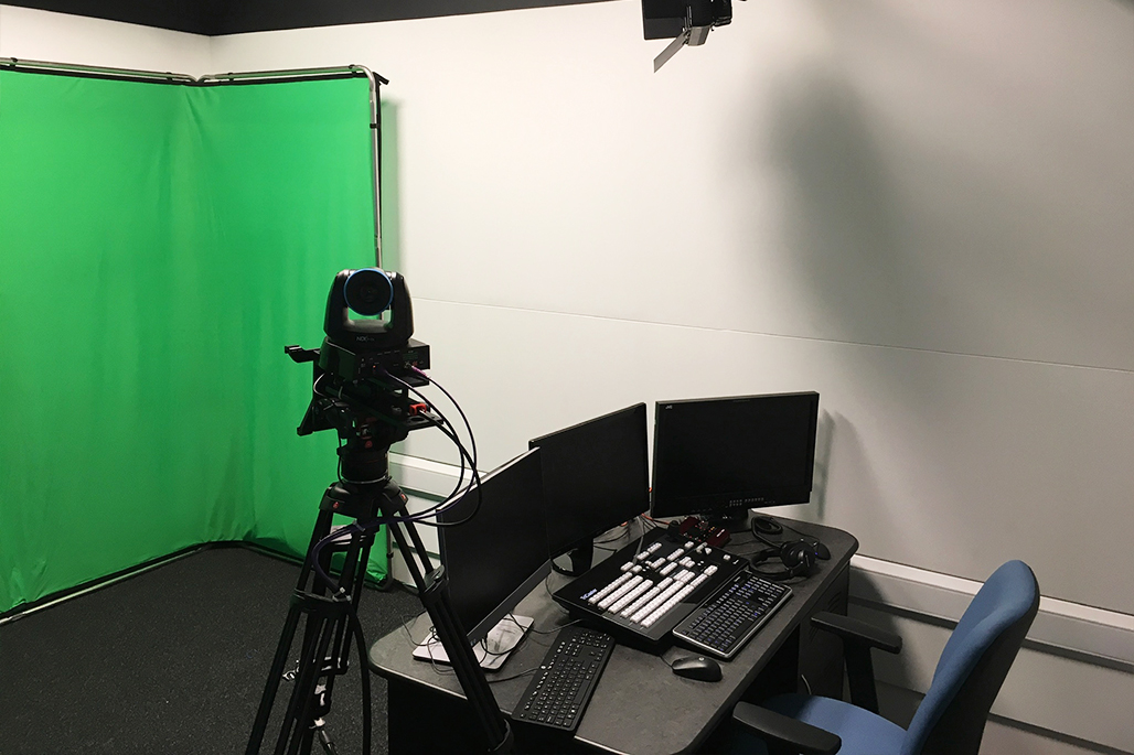 Green screen backdrop with computer equipment