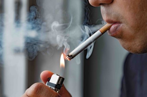 A smoker takes a drag on a cigarette