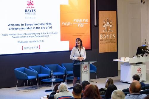 Aurore Hochard launches Bayes Innovate 2024 with a microphone