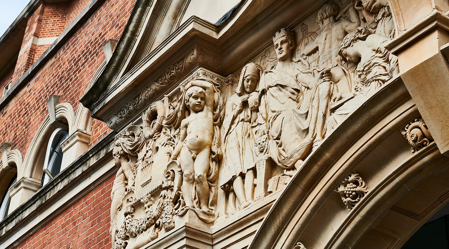 Carved stone frieze above the College Building entrance