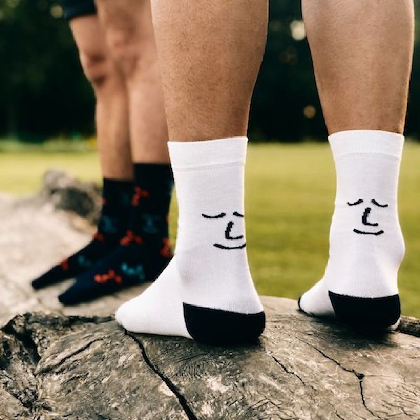 Two people wearing socks branded with Leiho logo