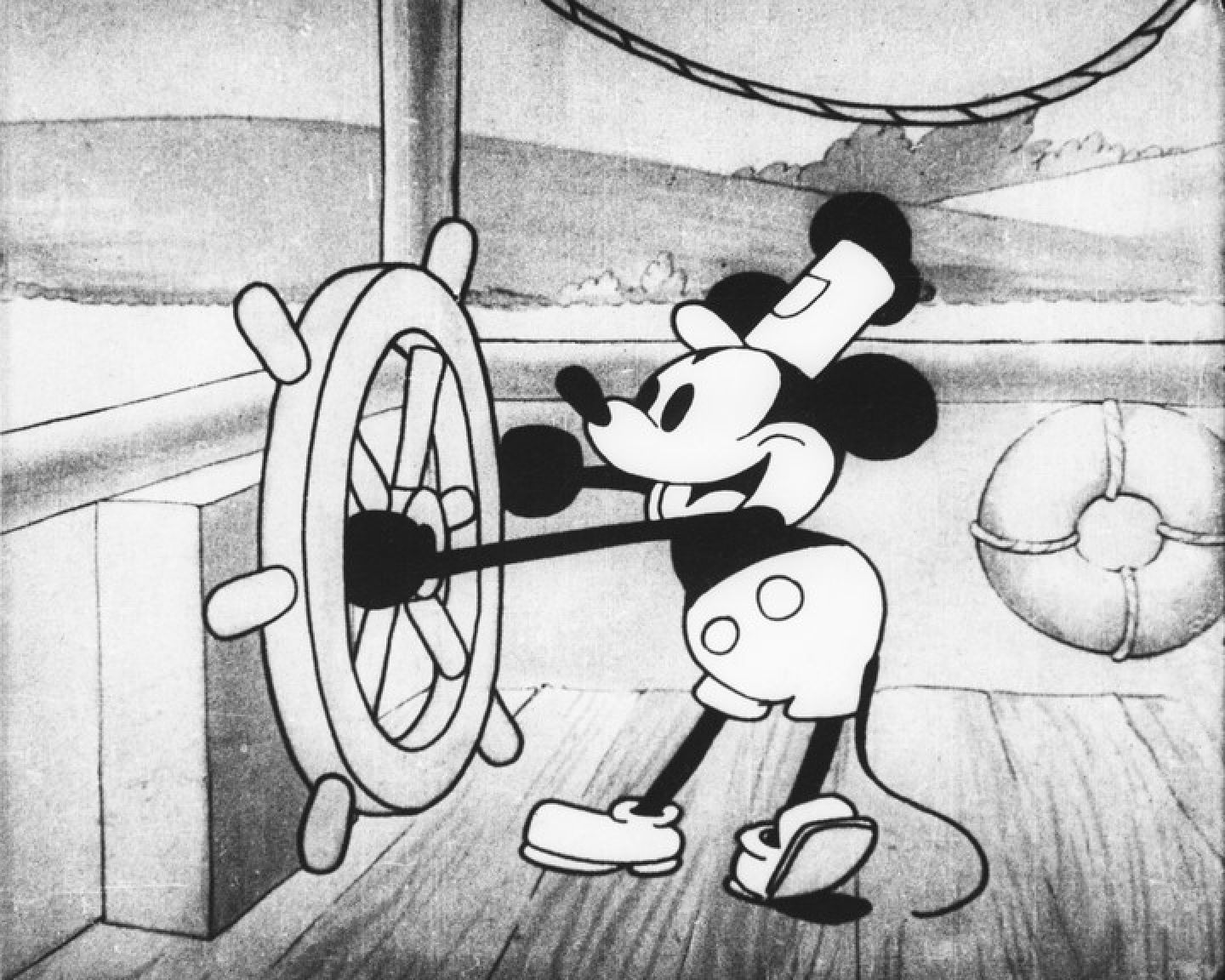 Mickey Mouse at the helm of a ship in Steamboat Willie