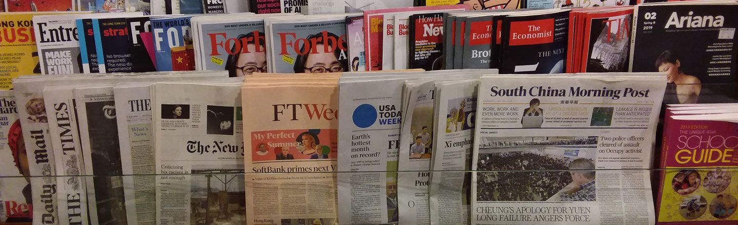 Newspapers and magazines on a rack