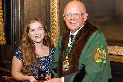 Bethany Higgins being awarded Masters Medal by Master Ian Davies