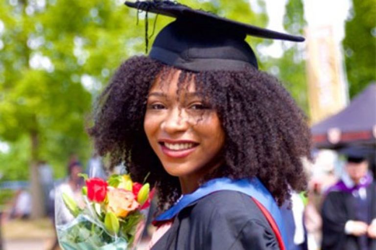 Headshot of student Dara Amos-Oluwole (MSc Human-Computer Interaction Design) at her undergraduate graduation wearing a mortarboard.