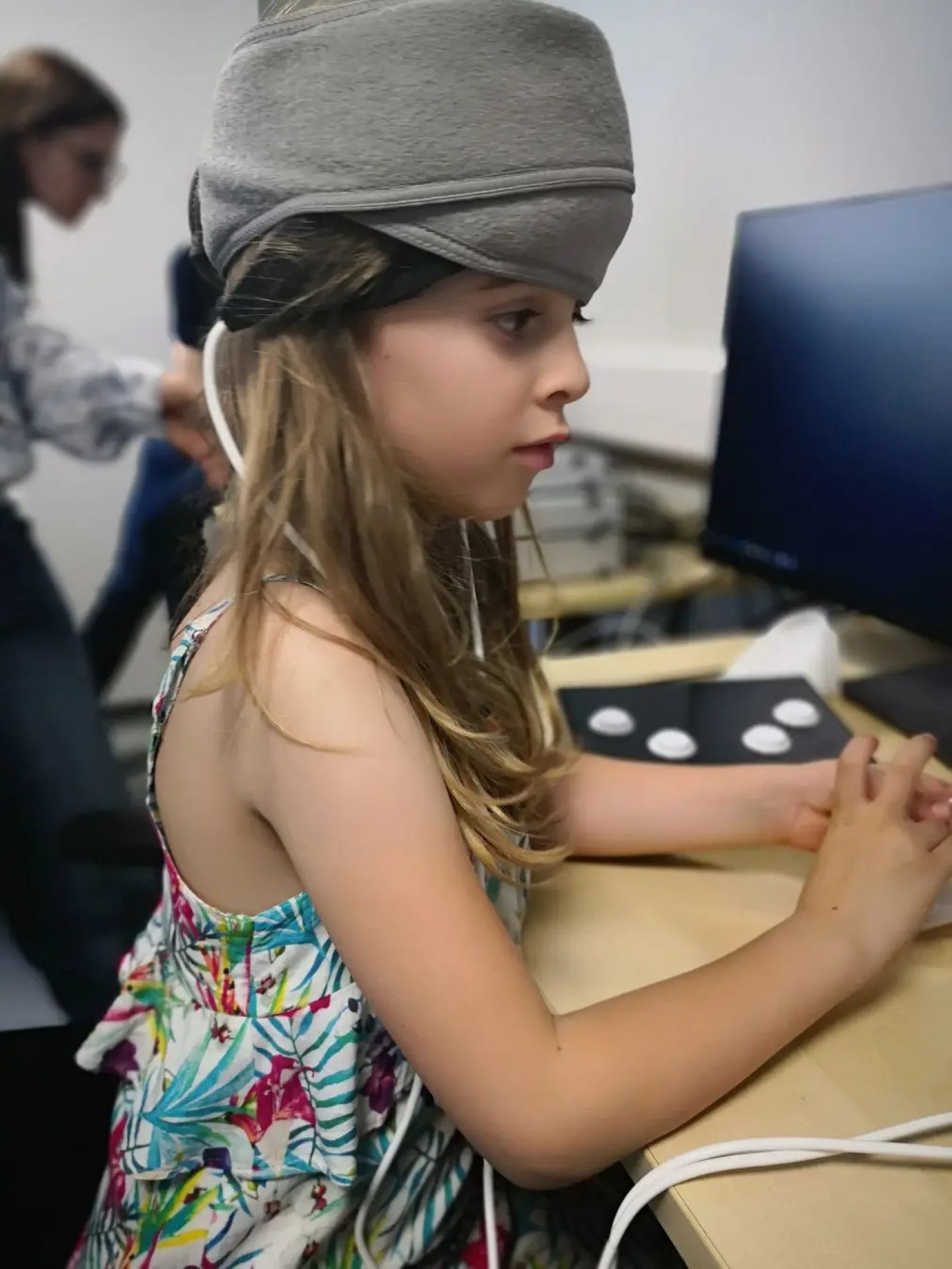 Child in Dr D'Souza's lab wearing a functional near-infrared spectroscopy neuroimaging device