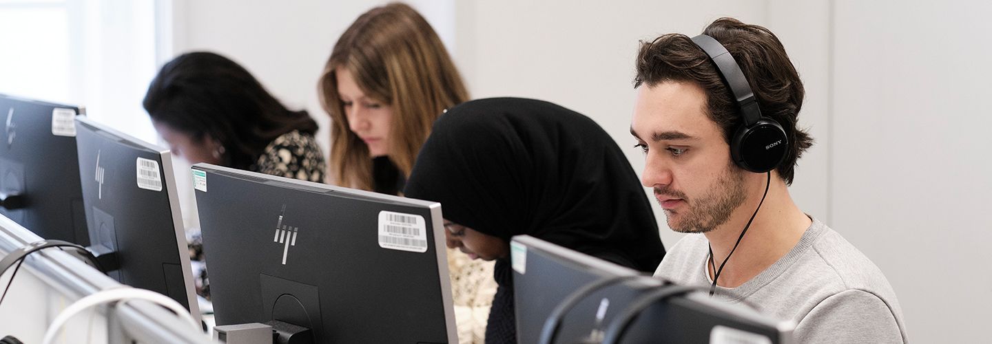 Postgraduate journalism students in a computer room