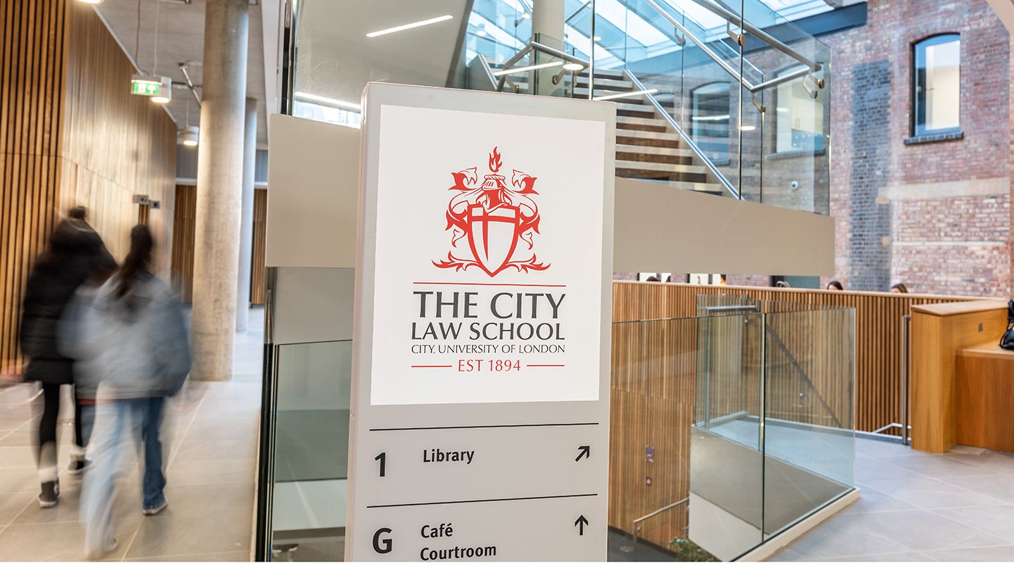 The City Law School entrance signage indicating the Library is on the first floor and the Cafe and Courtroom are located on the ground floor. 