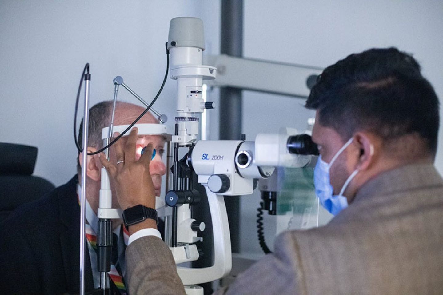 Prof Sir Anthony Finkelstein having eyes examined by a teaching optometrist