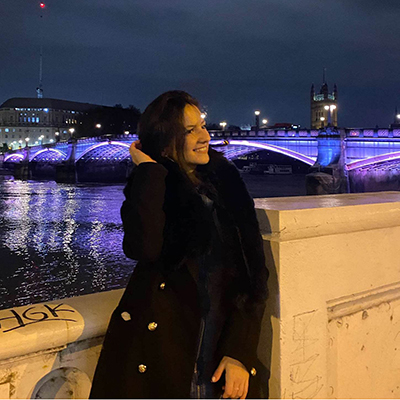 Maria Sturzu standing at a bridge in the evening
