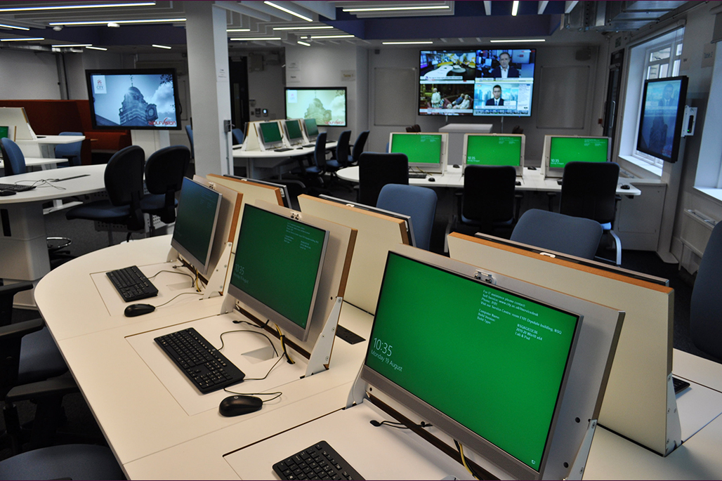 Multimedia suite showing pop up computers in the centre with clear view of all 4 tables