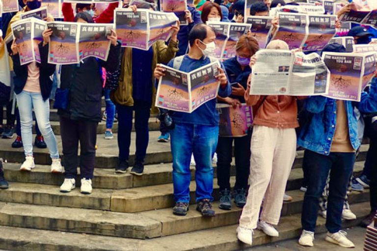 Hongkongers queue to buy a copy of the last-ever edition of Apple Daily