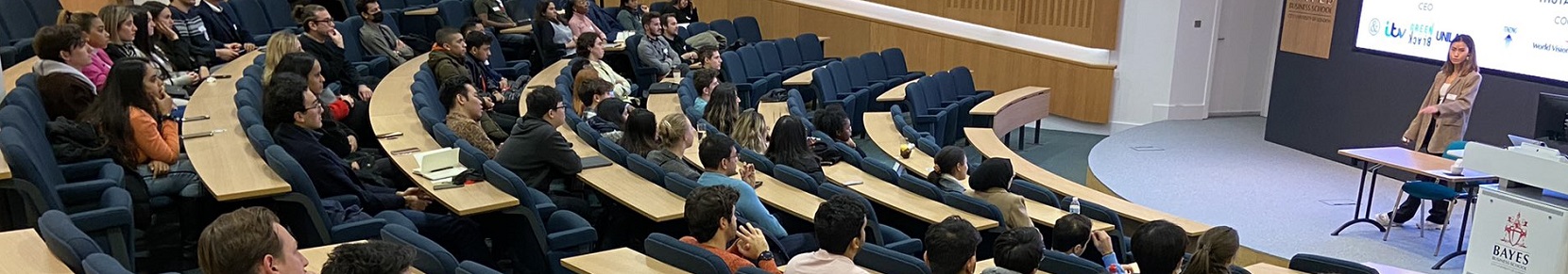A group of students listens to entrepreneur Joey Li
