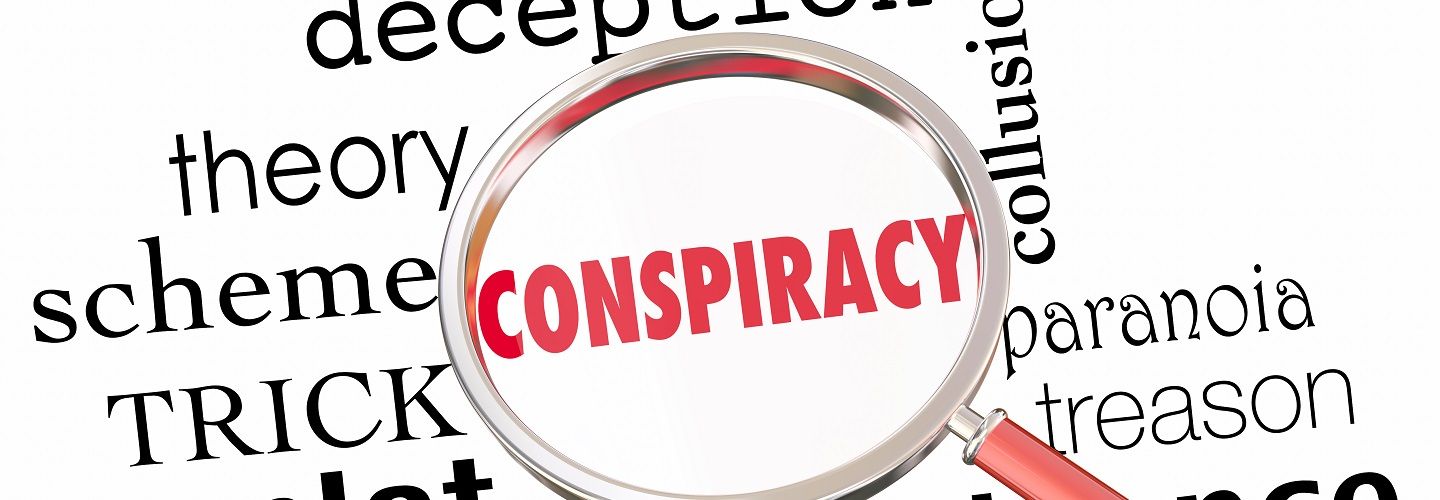 Image of conspiracy theory related words and a magnifiying glass over the word conspiracy theory