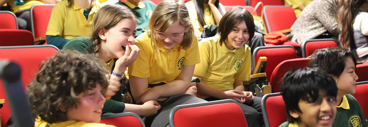 Islington schoolchildren sit in rows and laugh together at City's TV studio