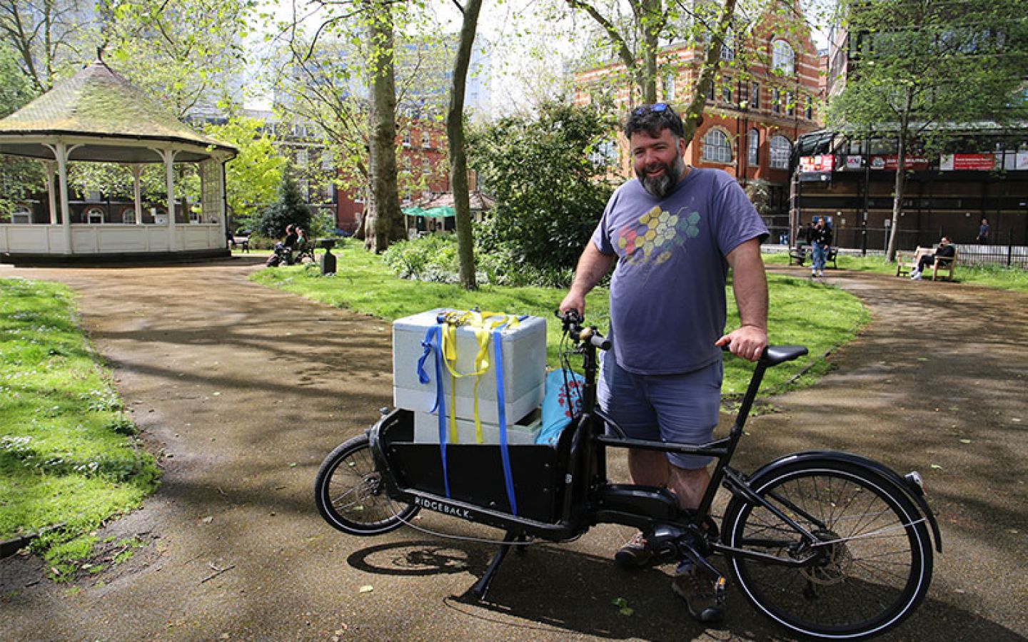 City's beekeeper, Barnaby Shaw from Bee Urban, transports a new colony of bees on a bike through Northampton Square