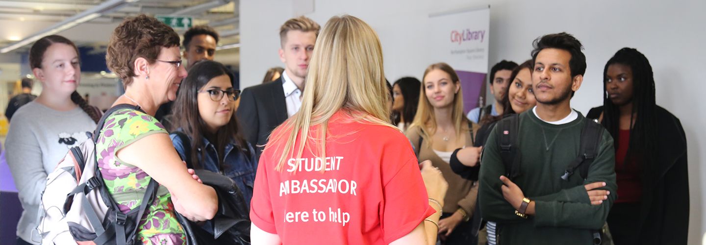 Student ambassador talking to a group of people