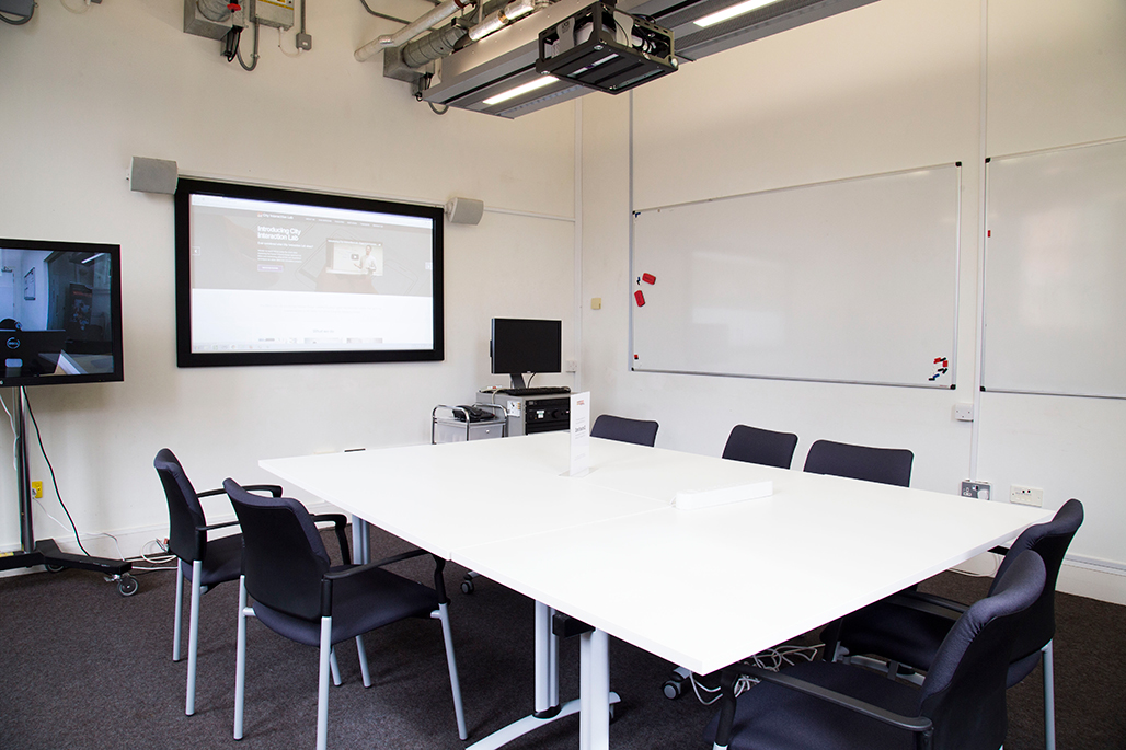 Interior of interaction lab featuring projectors and tables