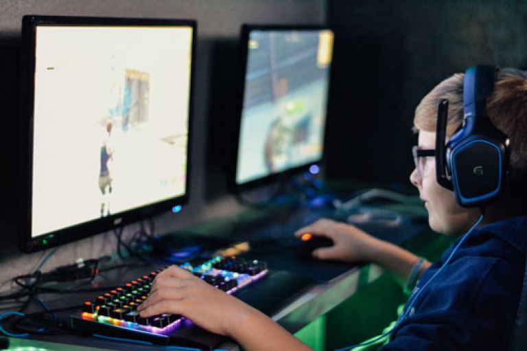 Young male gamer playing a war game