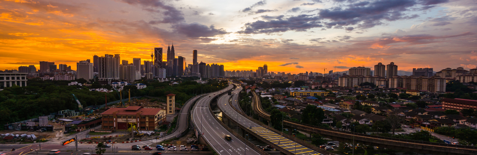 Sunset skyline over developing city
