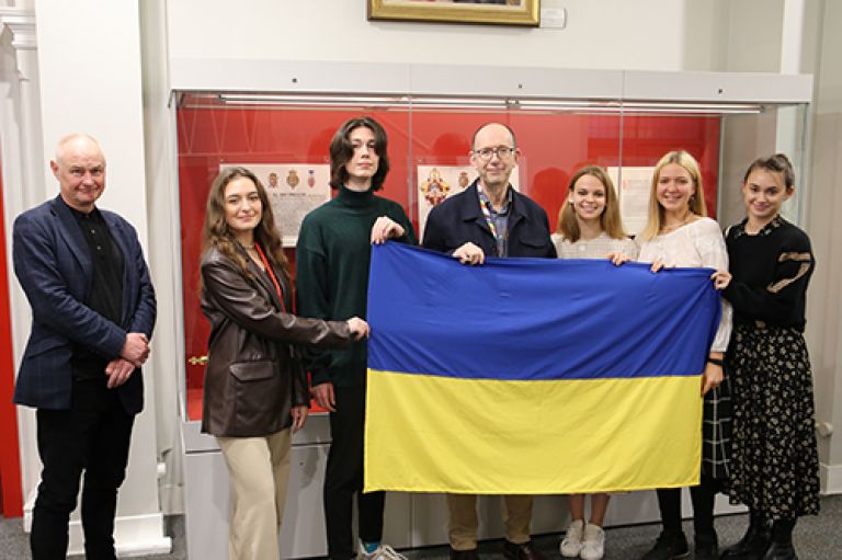 Dr James Rodgers and Professor Sir Anthony Finkelstein with Ukraniana Global University students holding the Ukranian national flag at the College Building ,City, University of London