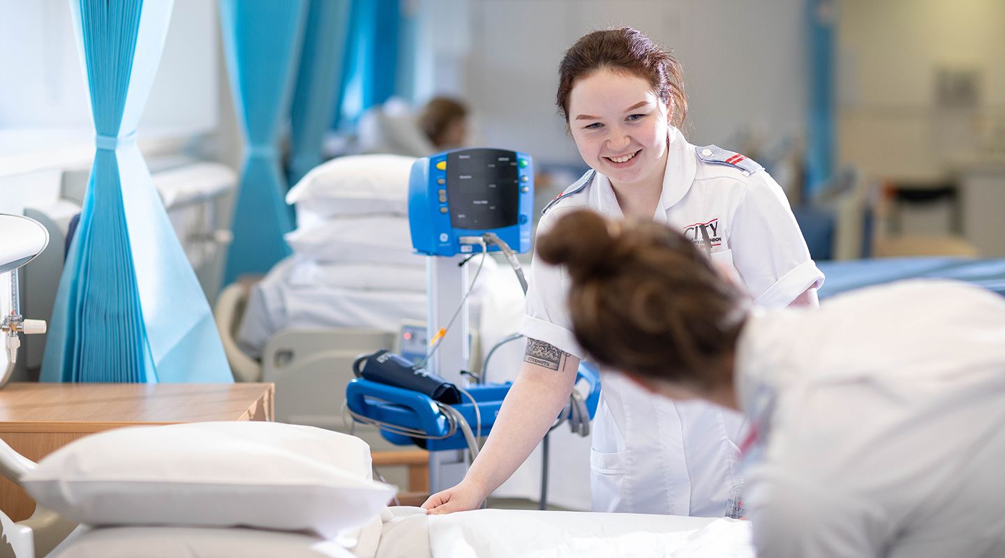 Two young female student nurses working together in the nurses ward at City.